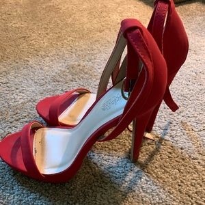 Worn once, red pump heels.